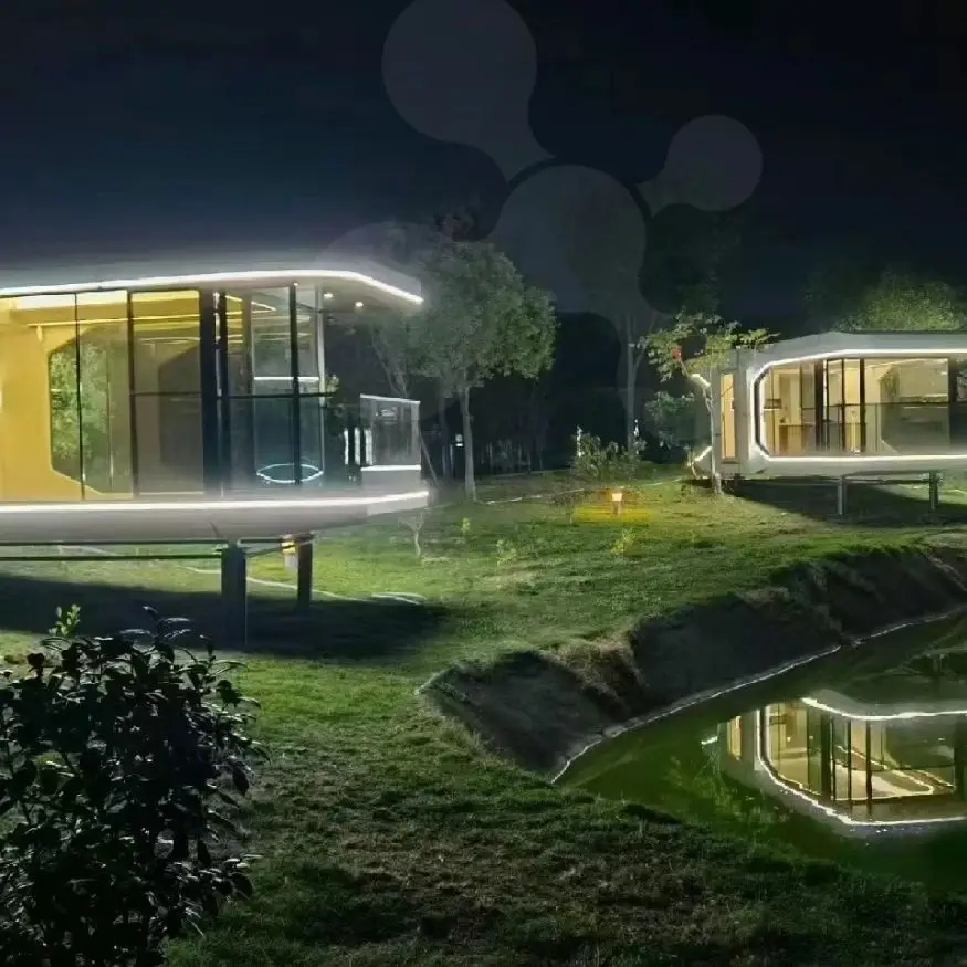 Modern illuminated buildings beside pond at night