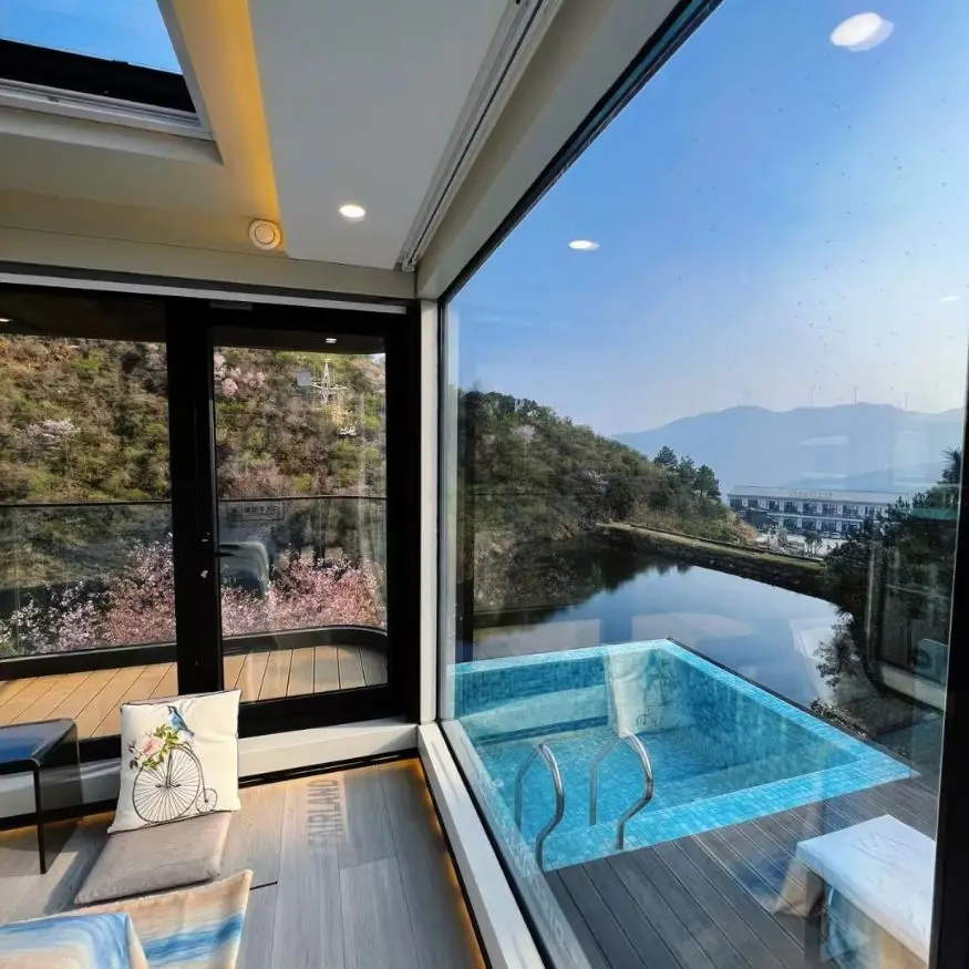 Modern room with mountain view and outdoor pool.