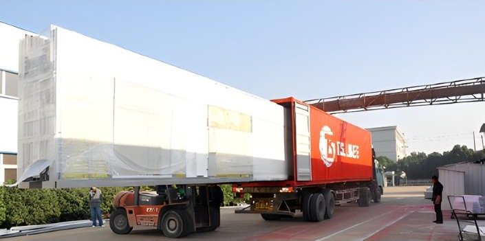 Large truck transporting industrial equipment on road